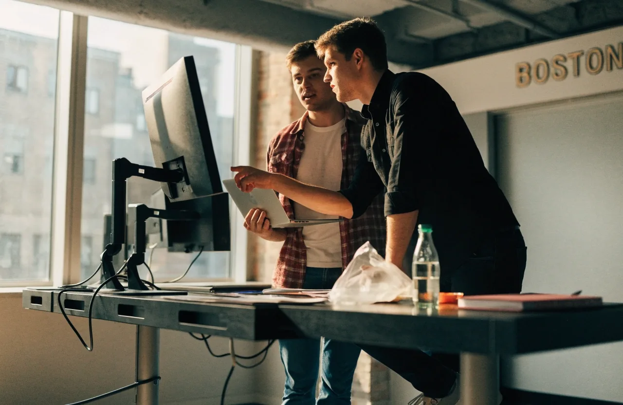 A developer and a colleague reviewing a running build during a short iteration cycle
